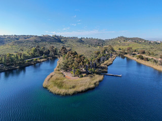 Fototapeta premium Aerial view of Miramar reservoir in the Scripps Miramar Ranch community, San Diego, California. Miramar lake, popular activities recreation site including boating, fishing, picnic & 5-mile-long trail.