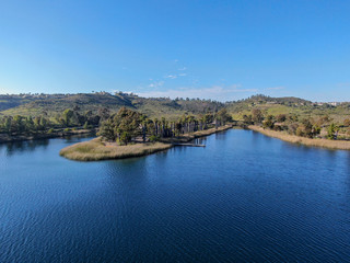 Fototapeta premium Aerial view of Miramar reservoir in the Scripps Miramar Ranch community, San Diego, California. Miramar lake, popular activities recreation site including boating, fishing, picnic & 5-mile-long trail.