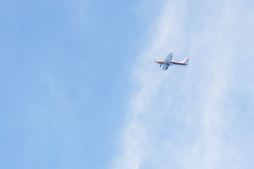 Fototapeta na wymiar Private jet against blue sky and clouds, Puglia, Italy