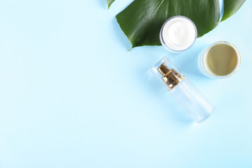 Moisturizing care skincare face cream for healing complicated troubled skin type in an open jar with visible texture. Copy space, close up, background, flat lay, top view. Monstera leaf decoration.