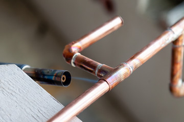 Closeup professional soldering copper pipes gas burner. Concept installation, plumbing replacement,...