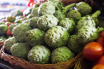 Fresh artichokes on market counter