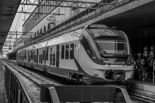 Black and white image of a train stopped at the Roma Termini Train Station in Rome - Italy