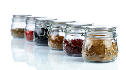 Various Oriental spices and herbs in glass jars.