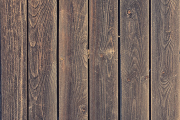 Fototapeta premium A fence of smooth wooden planks. Background with texture of old wood. Photo for layouts.