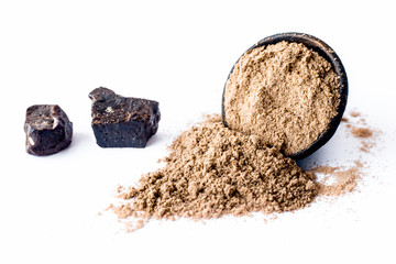 Raw hing or asofoetida or devil's dung isolated on white with its power also.