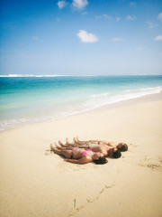 Fototapeta na wymiar Friends enjoying on a sandy tropical ocean / sea beach.
