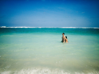 Couple enjoying on a sandy ocean tropical beach.
