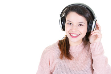Studio portrait of adorable happy smiling young woman relaxing in headphones