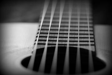 Fototapeta premium Old acoustic guitar with cracks on the soundboard close up. Black and white