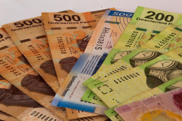 top view mexican pesos with white background (bills of different denominations)