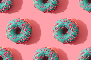 Minimal seamless pattern of donuts on coral background. Top view
