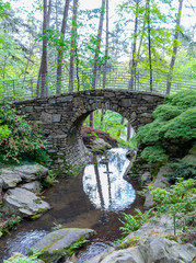 Stone bridge with a stream in a forest in  the Ozark mountains Arkansas