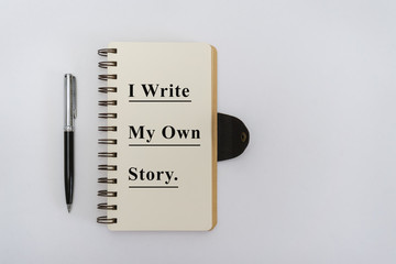 Notebook with Motivational Quote and Pen on White Background