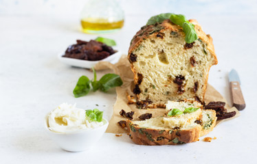 Savoury loaf cake with dried tomatoes, mozzarella and basil. Selective focus.