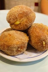 Bola de Berlim, Berlin Ball, a Portuguese pastry made from a fried doughnut filled with sweet eggy cream and rolled in crunchy sugar