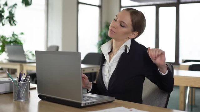 Office worker suffering back pain, sitting on uncomfortable chair, muscle strain