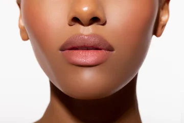 Fotobehang Beautiful lips Close-up. Makeup. Fashionable portrait girl in neon light background. Portrait of beautiful black woman. Sexy bodily Lips close up.      © Julia