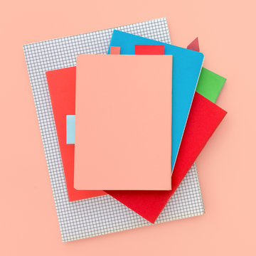 Stack Of Notebooks On Colorful Background. Top View.