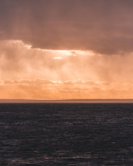 Sunset at sea with sunlight coming through the rain clouds, Finland