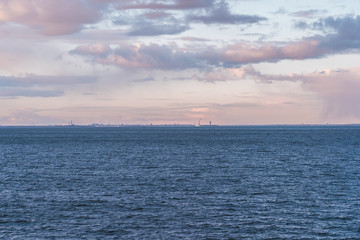 Fototapeta premium Helsinki in the horizon at sunset with a ship entering the port, Helsinki Finland