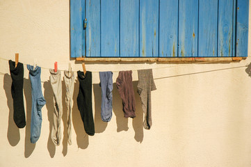 In a beautiful village in Sicily, a summer and sunny day some socks hanging.