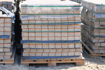 Construction Materials. Pile of gray bricks at construction site. Building materials for construction of buildings and structures.