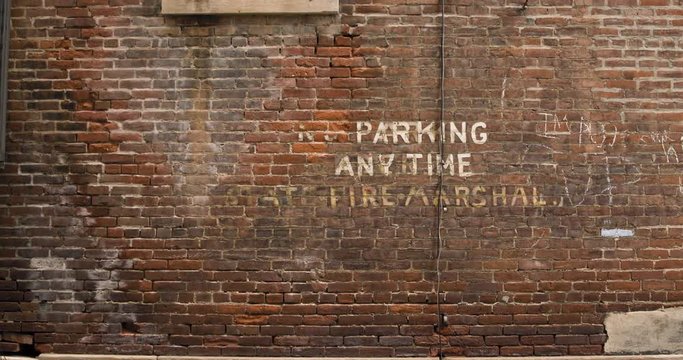 Brick Wall with Painted No Parking Anytime - Fire Marshal Sign