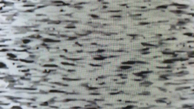 locked shot of filmed analogue tv interference and white snow, video drop outs and glitch, moire and distortion effect on picture tube LEDs