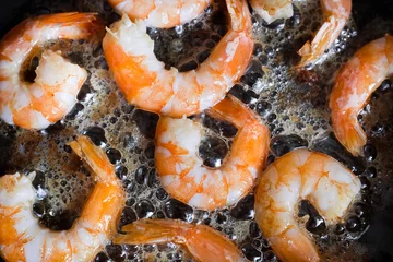 shrimp roasting in a pan in oil, cooking, close-up