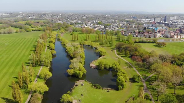Aerial view turning left over the lake in the middle of Gloucester Lake, Basildon on a sunny day