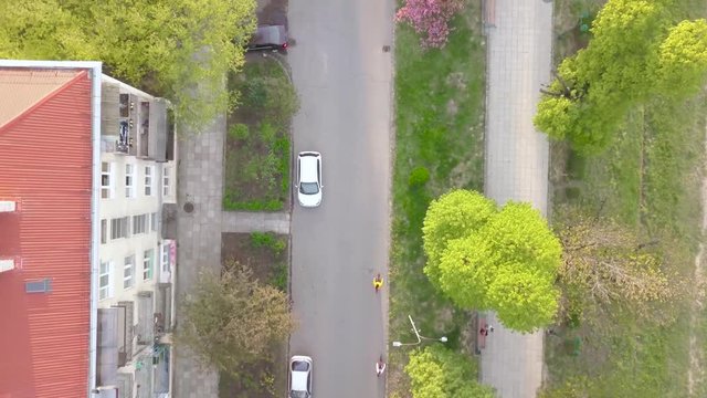 Drone Aerial Bird View of Street With Bicycle Riders in Uzhhorod West Ukraine Zakarpattia Region on Spring Day With Beautifull Colorful Trees