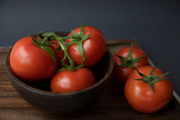 fresh tomatoes on wooden table