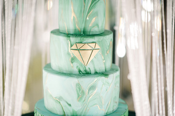 Large green wedding cake close-up on the wedding table