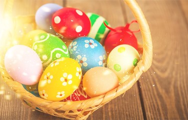 Obraz na płótnie Canvas Easter basket filled with colorful eggs