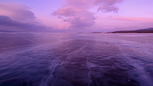 4K. Sunset in the icy Lake Baikal in the red colors, Irkutsk region, Russia. Ultra HD, 4096x2304