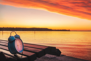 Alarm clock and sunrise over Lake Constance