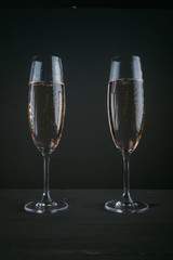 Pair of glasses of champagne on a dark background