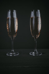 Pair of glasses of champagne on a dark background