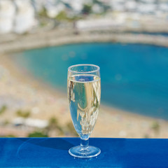 The glass of wine against the picturesque sea view illustrating the holiday and relax atmosphere.