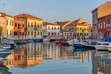 Sunset Canal - Sunset view of calm and colorful Canale San Donato on Murano Islands. Venice,...