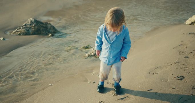 Little toddler playing on the beach