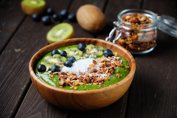 Smoothie bowls. Healthy breakfast bowl with chia seeds, muesli, berries, fruits and coconut flakes coconut flakes. Vegan food