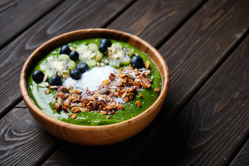 Smoothie bowls. Healthy breakfast bowl with chia seeds, muesli, berries, fruits and coconut flakes coconut flakes. Vegan food