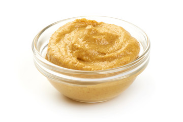 Mustard sauce in bowl, close-up, isolated on white background