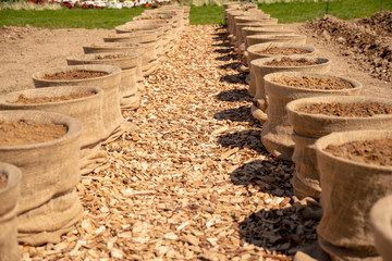 A bed with raised beds of potato sacks placed in a row