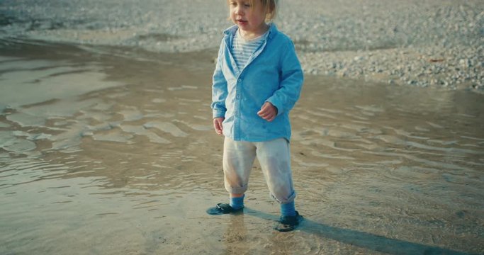 Little toddler standing in the sea