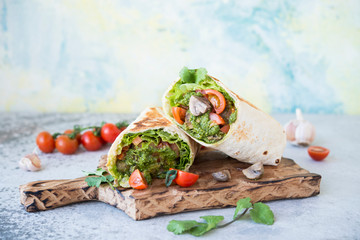 Burrito wraps with vegetables and sauce pesto.Roll with vegetables, mushrooms and pesto sauce. Vegetarian kebab. Of diet food.