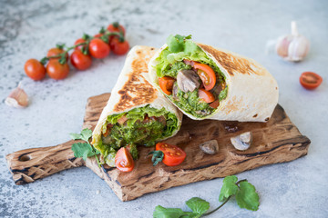 Burrito wraps with vegetables and sauce pesto.Roll with vegetables, mushrooms and pesto sauce. Vegetarian kebab. Of diet food.