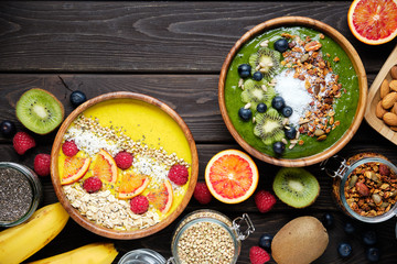 Smoothie bowls. Healthy breakfast bowl with chia seeds, muesli, berries, fruits and coconut flakes coconut flakes. Vegan food